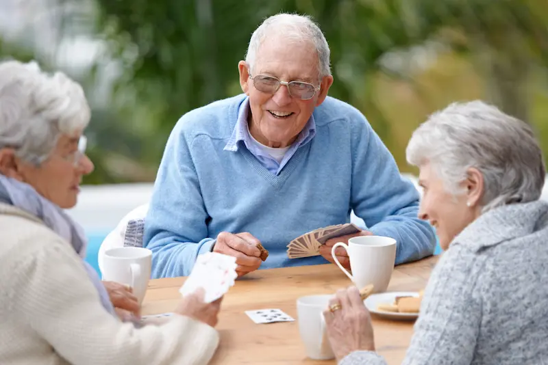 The Gardens of Buda | Seniors playing cards outside