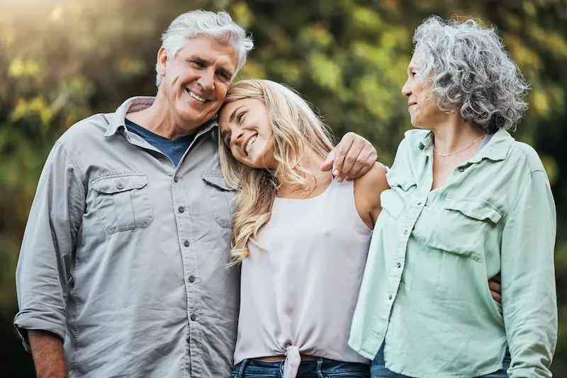 The Gardens of Buda | Seniors and their daughter walking in a park